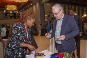 Global 50/50 Co-CEO, Kent Buse, gives his business card to another convening participant