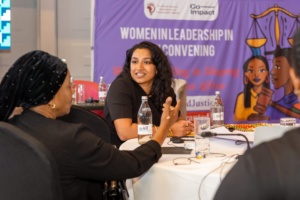 Global 50/50 Justice Sector lead, Govindi Deerasinghe, is sat around a table at the convening, talking to another participant